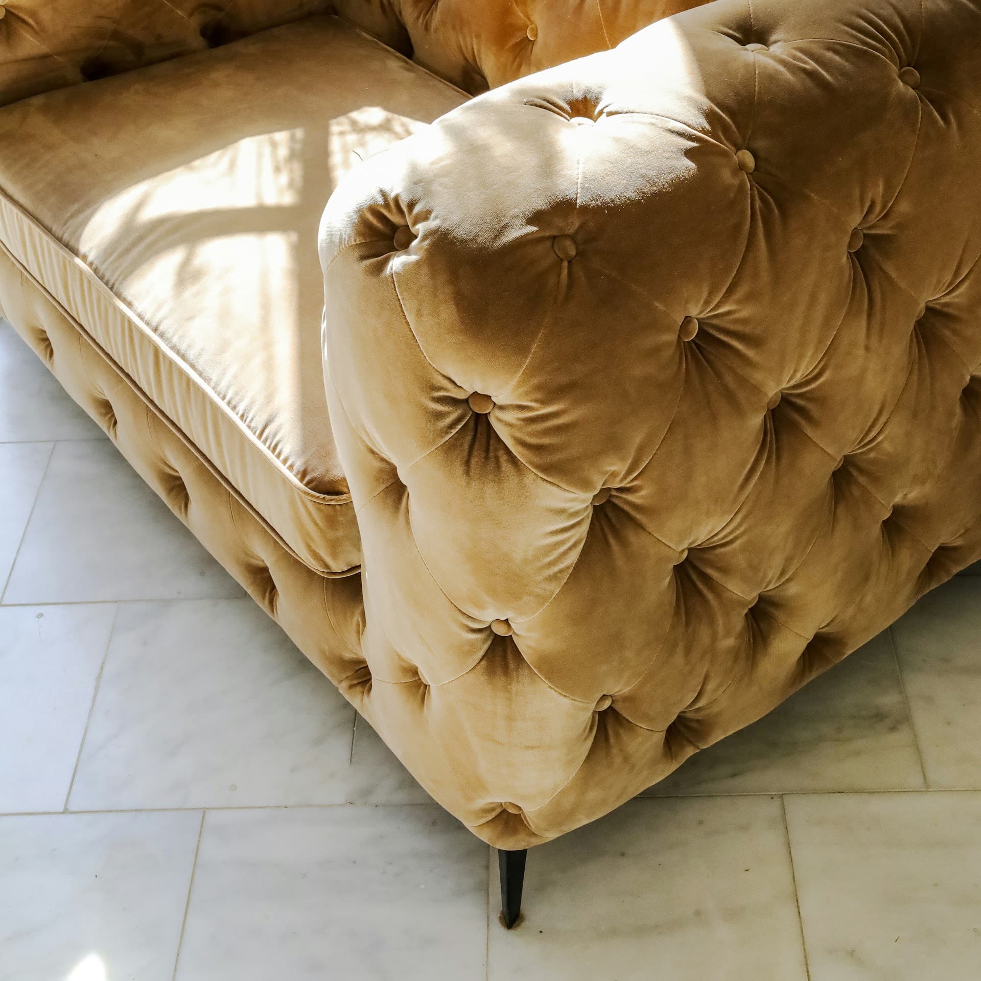 A buttoned velvet chesterfield reupholstered by Crown Upholstery