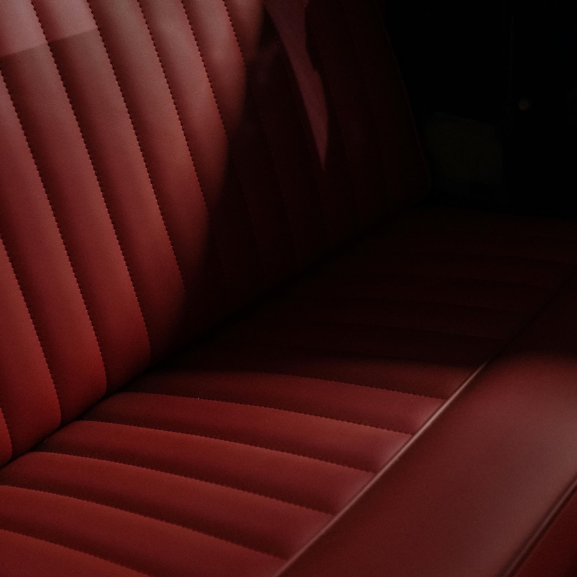 Deep red pleated leather bench seat upholstered by Crown Upholstery
