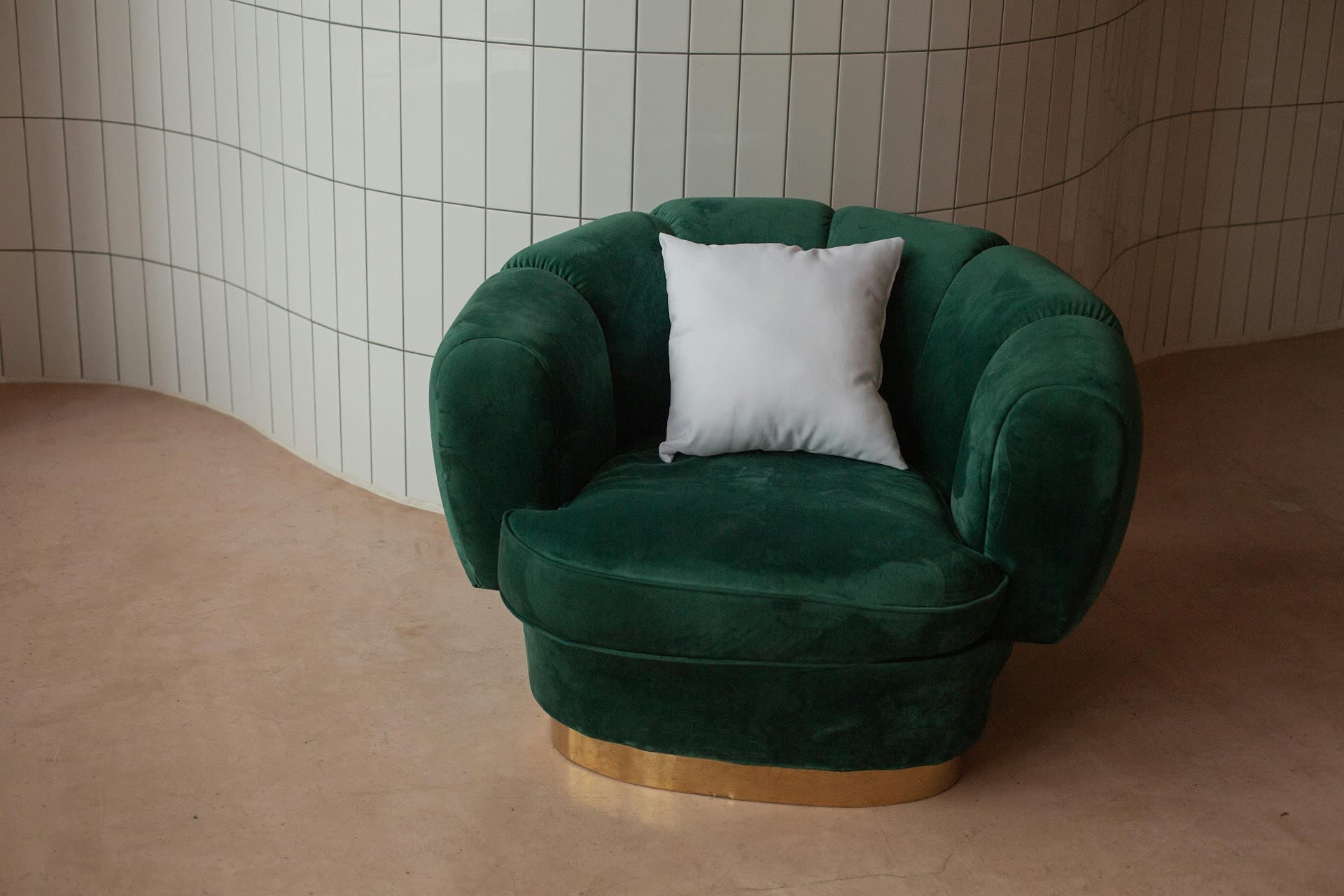 Green velvet tub chair with brass base