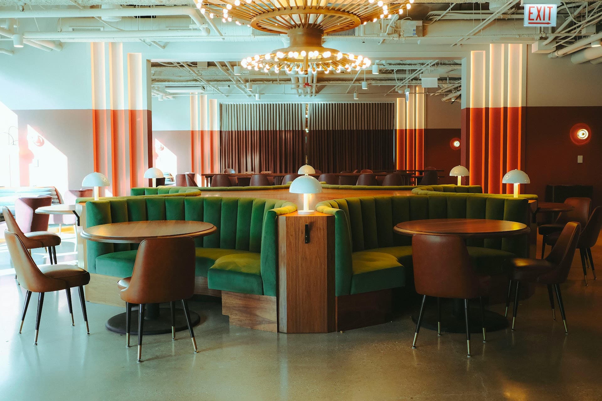 Curved restaurant booths upholstered in green